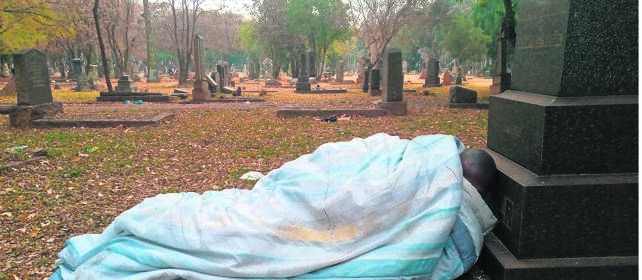 Homeless Linda Sokhela sleeps at Langlaagte Cemetery. Photo byZamokuhle Mdluli