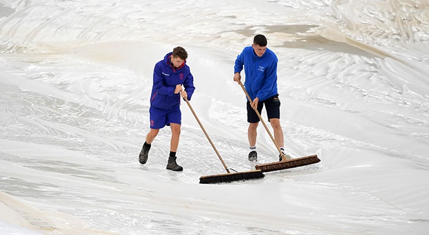 Ground staff hard at work on the Rose Bowl turf after Monday's rain (Getty).