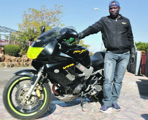 Thabane Ndaba, from Soweto, with his Honda.     Photo by Thabo Monama