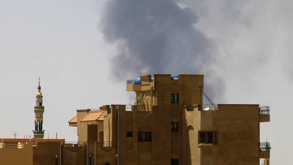 Smoke billows over residential buildings in Kharto