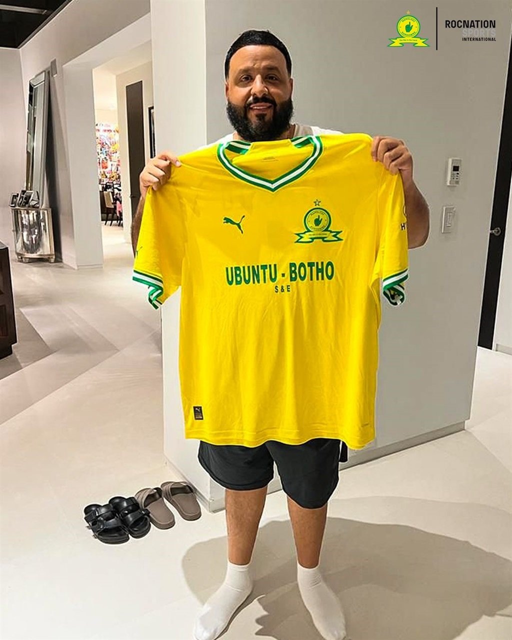 DJ Khaled holding up a Sundowns jersey that he received from the club last season.