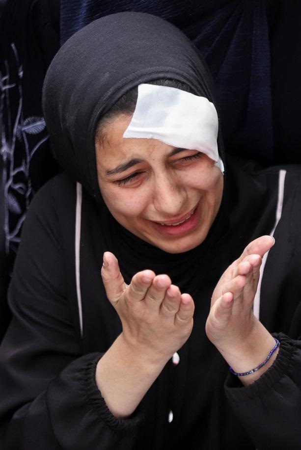 A wounded Palestinian mourner reacts next to the bodies of relatives killed in Israeli strikes, amid the ongoing conflict between Israel and the Palestinian Islamist group Hamas, during their funeral in Rafah, in the southern Gaza Strip, April 29, 2024. Photo by Reuters/Hatem Khaled