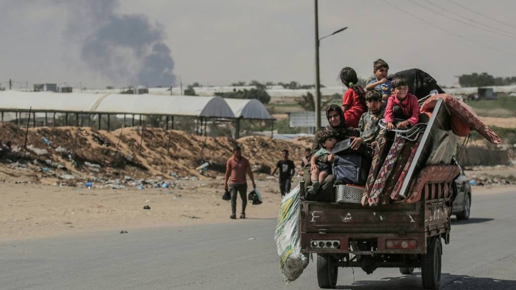 Palestinians flee with their belongings ride atop 