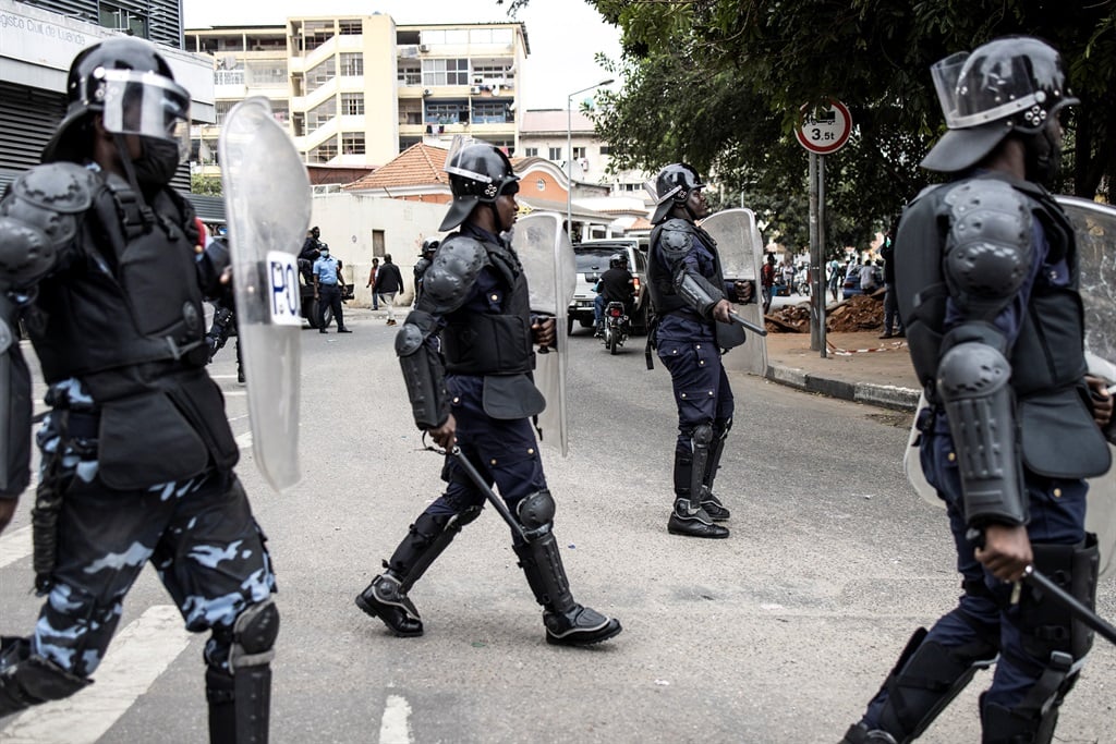 Angolan riot police take position after around a hundred people protest over wages in Luanda on 25 August 2022.