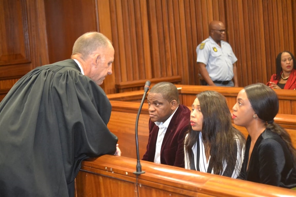 Defence lawyer Peter Daubermann consults with Timothy Omotoso and his two co-accused, Lusanda Sulani and Zikiswa Sitho, in the Port Elizabeth High Court. Photo by Luvuyo Mehlwana
