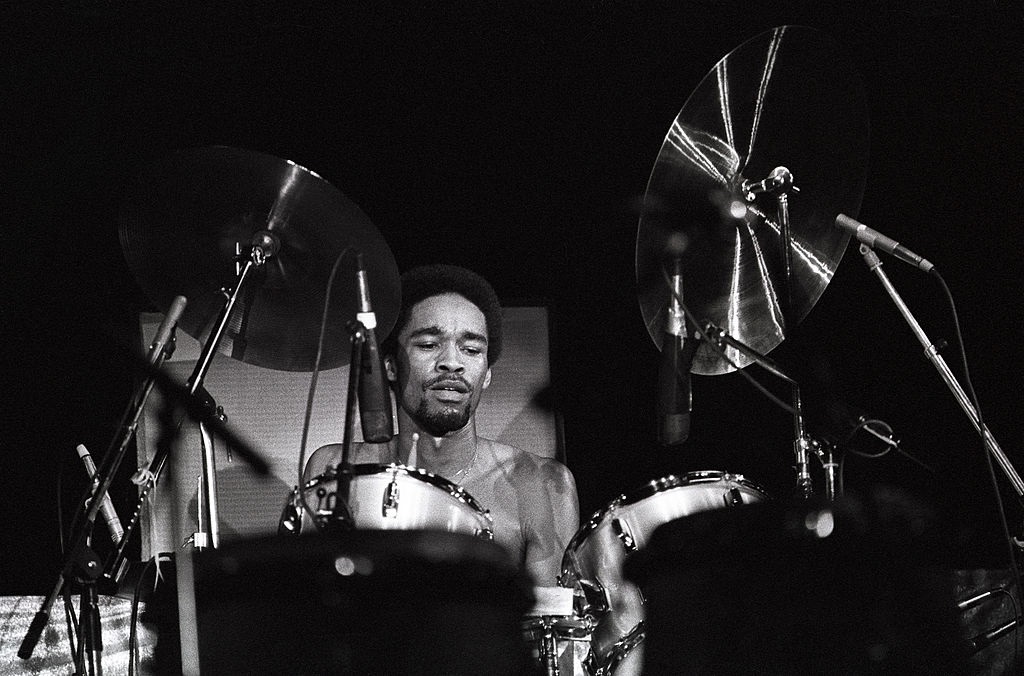 Drummer Fred White performing on stage.