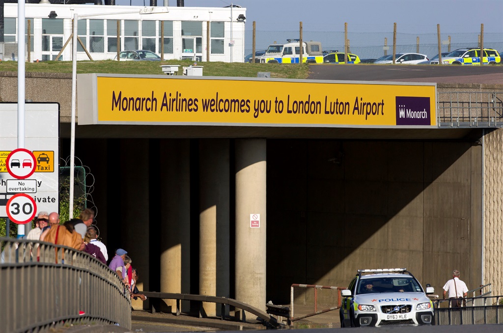 A police car drives away from London Luton airport on September 8, 2014, following a security alert and an evacuation of the main terminal building.