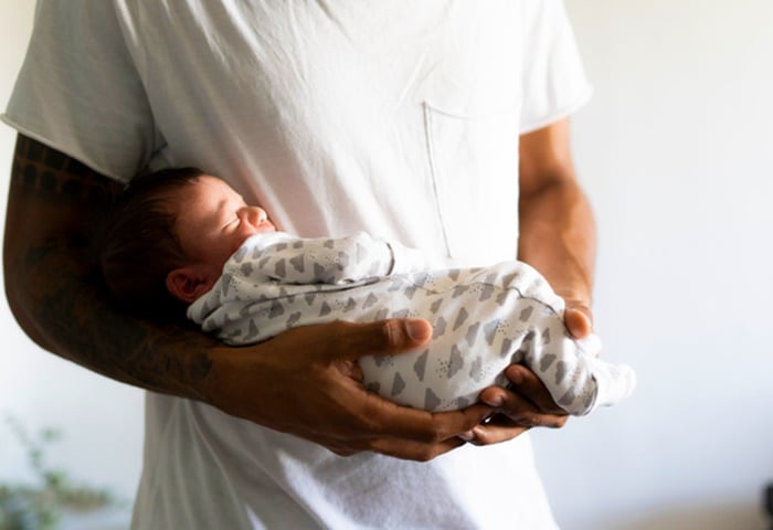 "Young fathers acknowledged that the caring role of a father is overtaken by a need to provide financially for their children."(Westend61/Getty Images) 