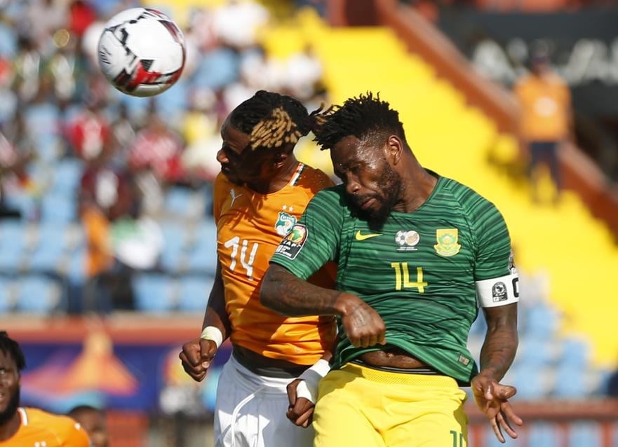 Ivory Coast's Jonathan Kodjia (left) and Bafana Bafana's Thulani Hlatshwayo jump for the ball during their African Cup of Nations group D match at Al Salam Stadium in Egypt. Picture: Ariel Schalit/AP