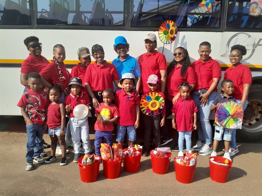 Petunia Moon Nursery and Pre-Primary School principal, Sarah Nkosi (blue T-shirt) with some of the parents and children.