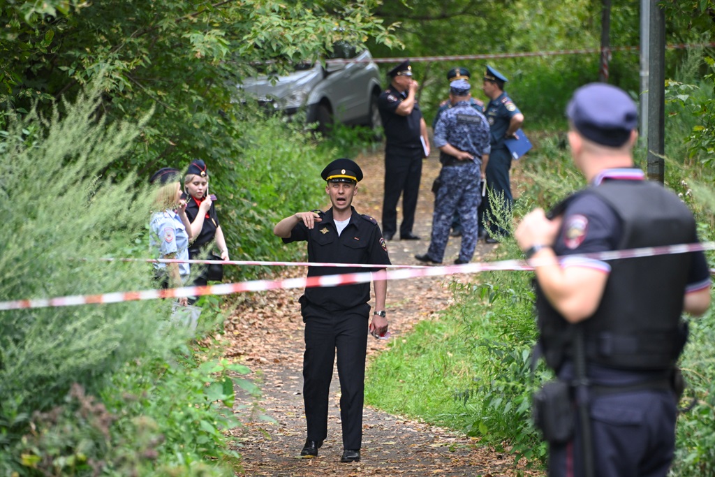Police officers work at the site where a Ukrainian drone targeting the Russian capital was downed by air defence system, in western Moscow on 11 August 2023.
