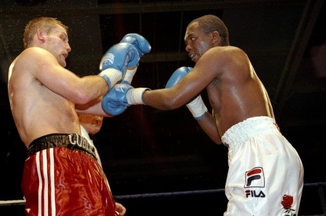 Cornelius Carr (left) fighting Dingaan Thobela during WBF Boxing at the David Lloyd Club in Raynes Park, London in 1999. (John Gichigi /Allsport)