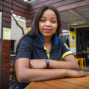 Waitress Ayanda Ndlovu sits outside BeerhouseFourways where she received a R18 000 tip from an anonymous customer. (Chanté Schatz, News24)