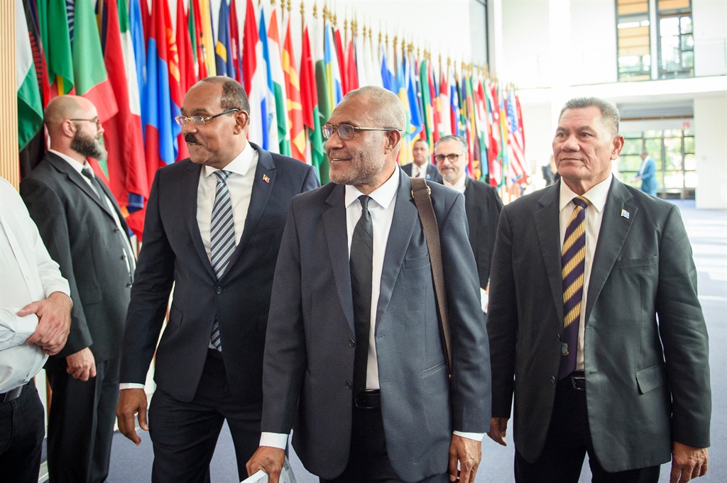 (Left to right) Gaston Browne, Prime Minister of Antigua and Barbuda, Arnold Loughman, Attorney General of Vanuatu, and Kausea Natano, Prime Minister of Tuvalu, arrive for a hearing at the International Tribunal for the Law of the Seas (ITLOS) on 11 September 2023 in Hamburg. (Photo by Gregor Fischer / AFP)