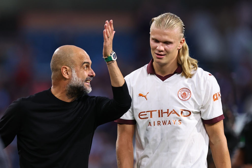 BURNLEY, ENGLAND - AUGUST 11: Pep Guardiola the head coach / manager of Manchester City reacts towards Erling Haaland of Manchester City during the Premier League match between Burnley FC and Manchester City at Turf Moor on August 11, 2023 in Burnley, England. (Photo by Robbie Jay Barratt - AMA/Getty Images)