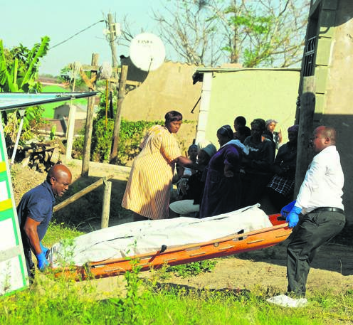 Mortuary employees remove the body of a woman allegedly murdered by her boyfriend yesterday.                     Photo by Phumlani Thabethe