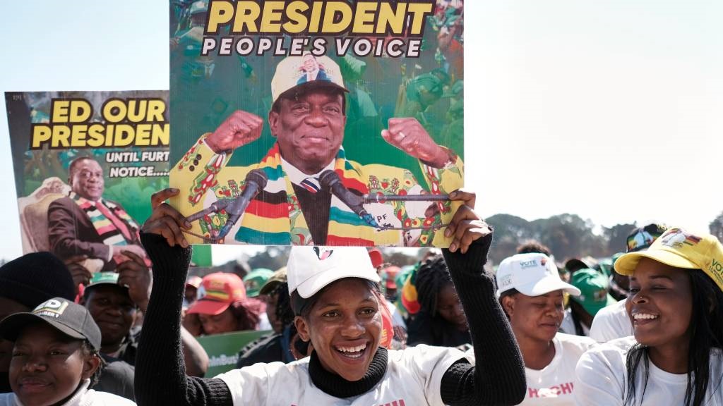 Supporters of Zimbabwe's ruling party ZANU PF hold