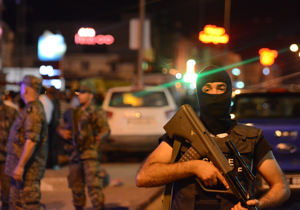 Tunisian security forces tighten security measures outside a metro station near the bus stop where a man reportedly wearing an explosive belt blew himself up in the early hours. (AFP)