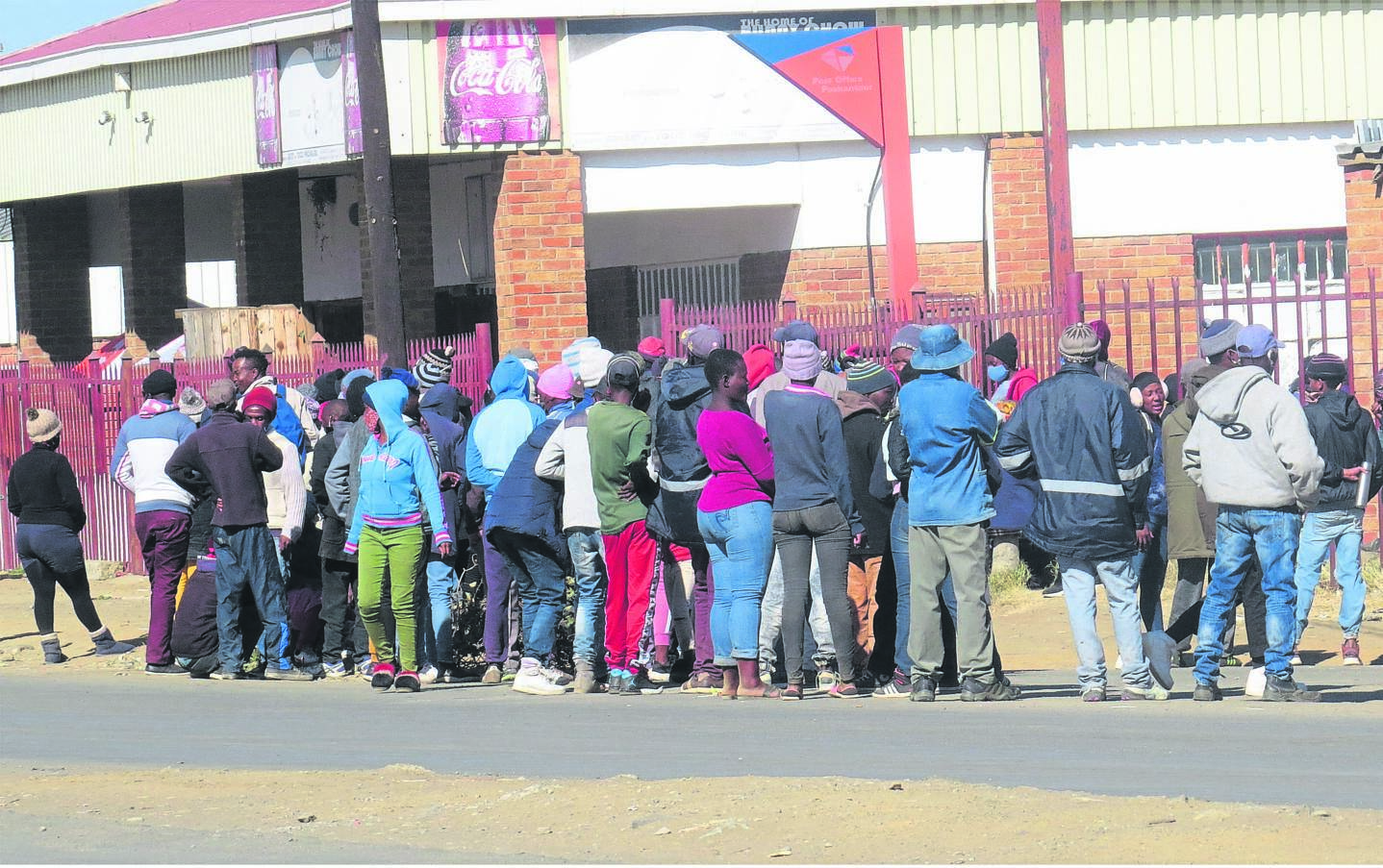 Scores of beneficiaries queue in this archive photo to receive the Social Relief of Distress outside a local post office in Rocklands, Bloemfontein. Photo: Teboho Setena