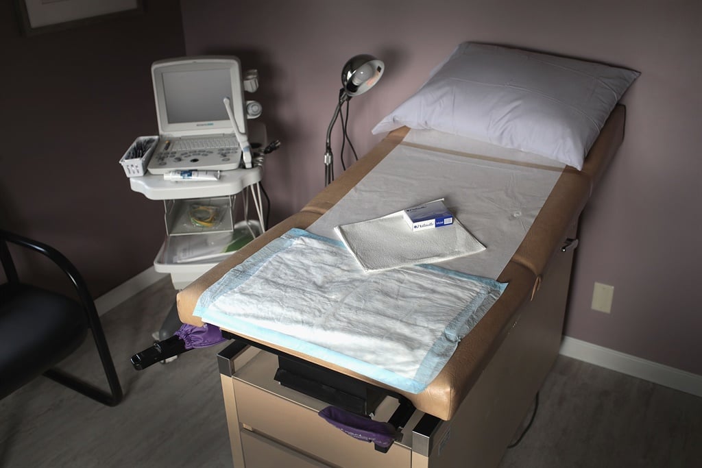 An ultrasound machine sits next to an exam table in an examination room at a women's health clinic. (Scott Olson, Getty Images, AFP)