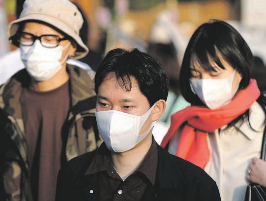 PROTECTING EVERYONE Surgical masks are often worn in Japan and are an effective way to prevent the spread of germs. Picture: Getty images