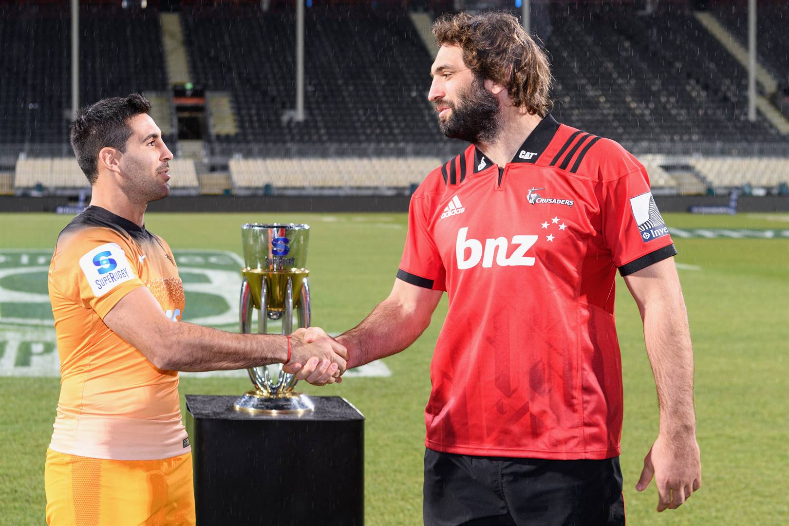 CAPTAINS Jeronimo de la Fuente of the Jaguares and Samuel Whitelock of the Crusaders shake hands as the Super Rugby trophy looming in the background at Orangetheory Stadium in Christchurch, New Zealand. Picture: Kai Schwoerer/Getty Images