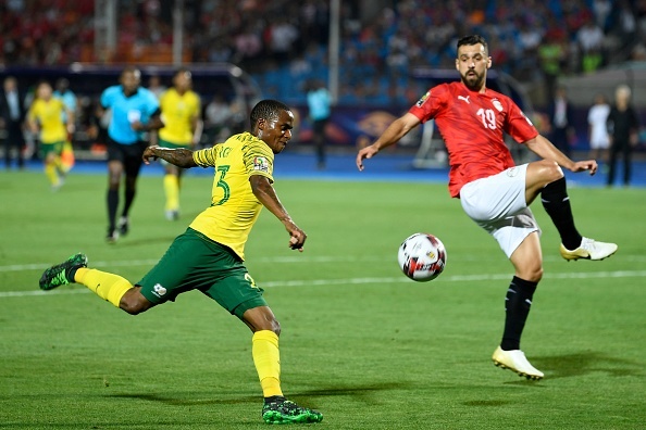South Africas midfielder Thembinkosi Lorch (L) attempts a shot as he is marked by Egypts defender Abdullah al-Saeed during the 2019 Africa Cup of Nations (CAN) Round of 16 football match between Egypt and South Africa at the Cairo International Stadium in the Egyptian Capital on July 6, 2019