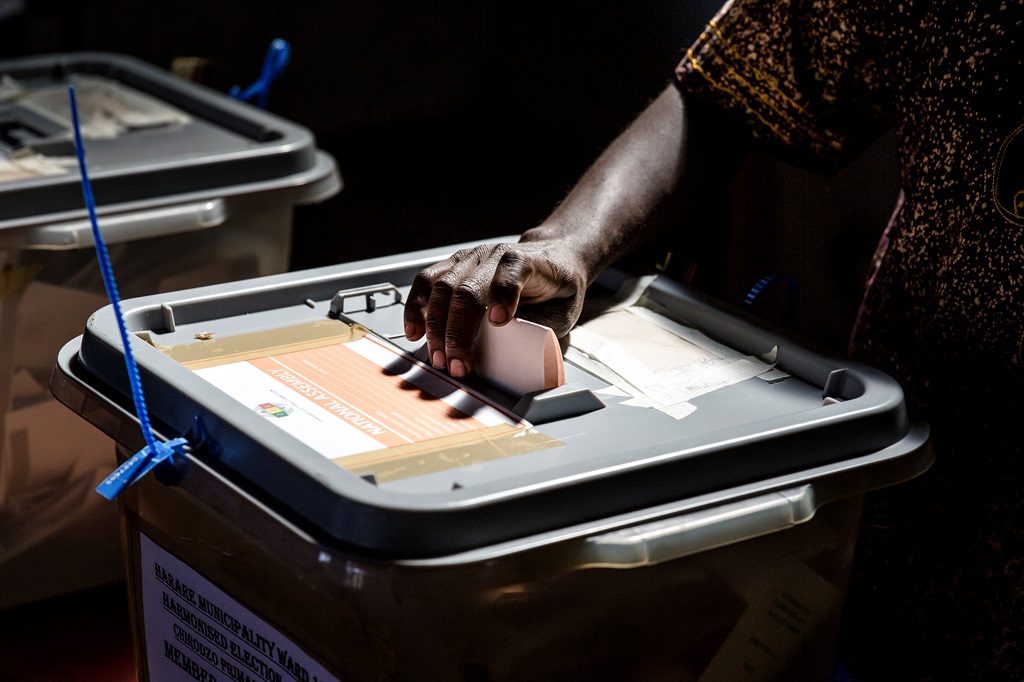 A man casts his ballot in a polling station located in the suburb of Mbare in Zimbabwe's capital Harare, on July 30, 2018. 