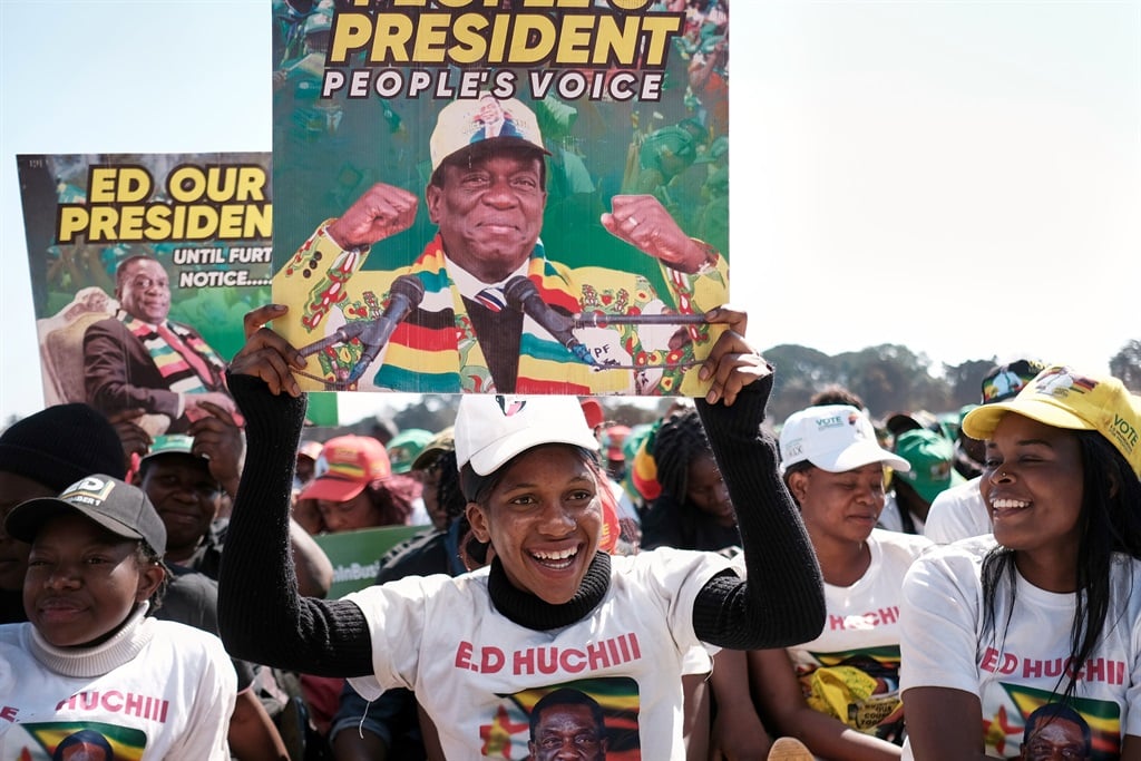 Supporters of Zimbabwe's ruling party ZANU PF hold