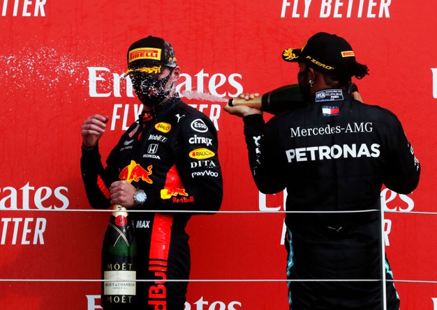 Race winner Max Verstappen of Red Bull Racing and second placed Lewis Hamilton of Mercedes celebrate on the podium  during the F1 70th Anniversary Grand Prix at Silverstone on August 09, 2020 in Northampton, England. (Photo by Frank Augstein/Pool via Getty Images)