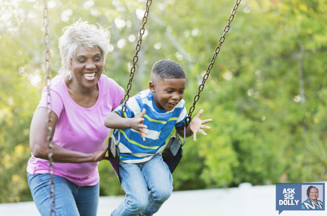 Grandmother pushes her grandson on the swing. 