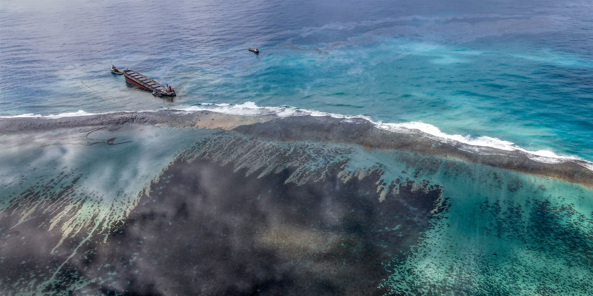 This aerial view taken on August 8, 2020 shows a large patch of leaked oil and the vessel MV Wakashio off the coast of Mauritius.