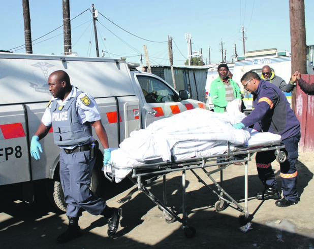 Paramedics remove the bodies of the three people who were killed in Sinqawunqawini.                     &#160;     Photo by Lindile Mbontsi
