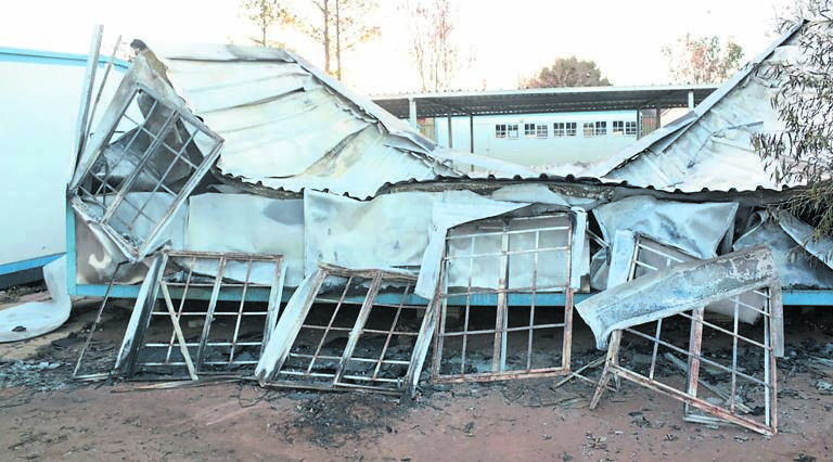 This classroom at Mountain View High is no longer fit for teaching. Inset: Contractor Nhlanhla Sikhakhane repairs some broken windows.    Photos by Muntu Nkosi