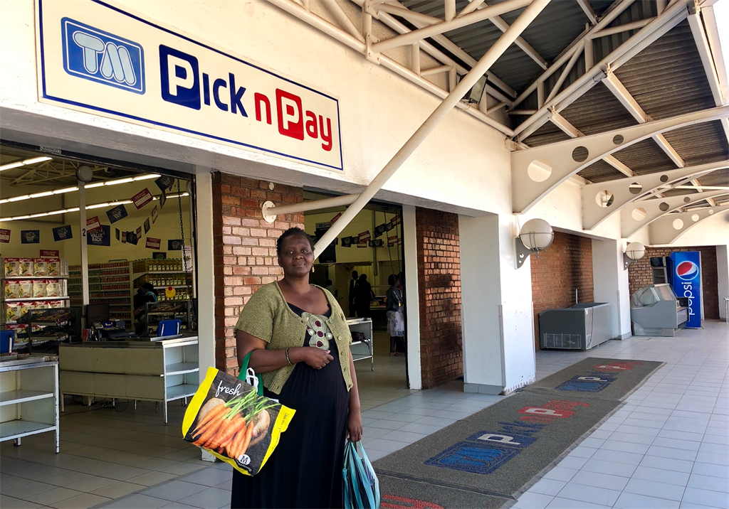 A shopper in front of a Pick n Pay store in Bulawa