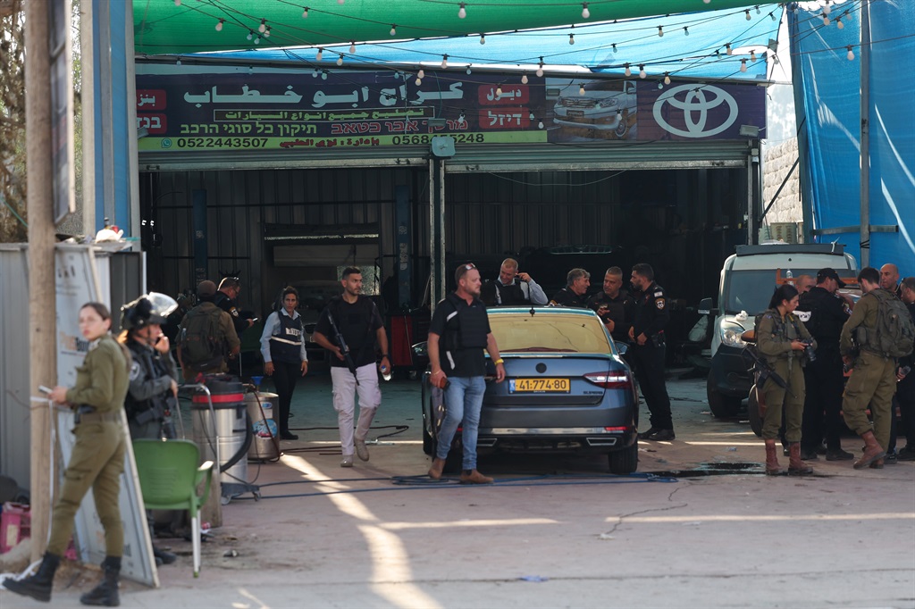 Israeli security forces stand guard at the site of