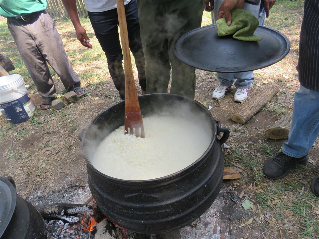 Wattville Men's Forum cooking traditional food. Photo by Ntebatse Masipa