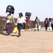 'We don't have a choice': Beds, fridges among the heavy loads unemployed Zimbabweans carry for money