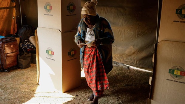 <p>A woman walks away from a voting booth after marking her ballot at a polling station during the presidential and legislative elections in Mbare, Harare. </p><p><em>(Photo by John Wessels/AFP)</em></p>
