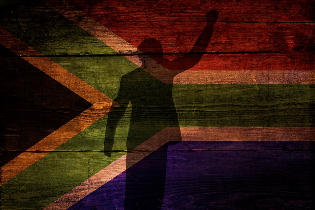 An South African flag on a grunge wooden backgroun