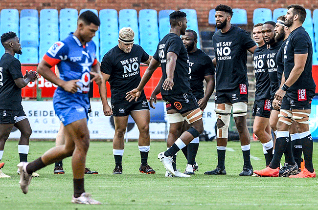 Sharks players take the field in T-shirts with a message