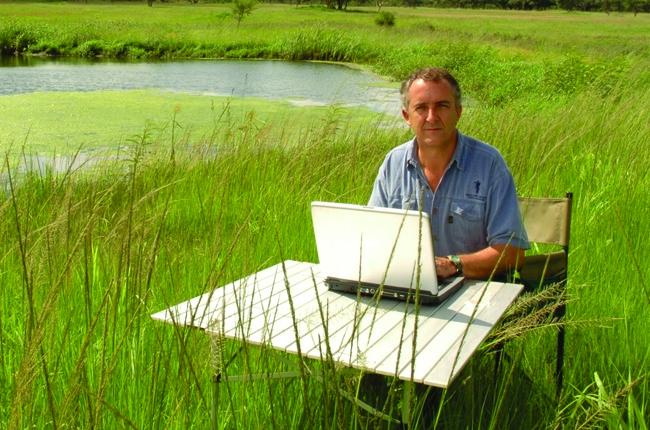 At work on his laptop at a game reserve near the Zimbabwe capital,Harare. The author has found the perfect way to combine work and play – his adventures
inspire his books.
