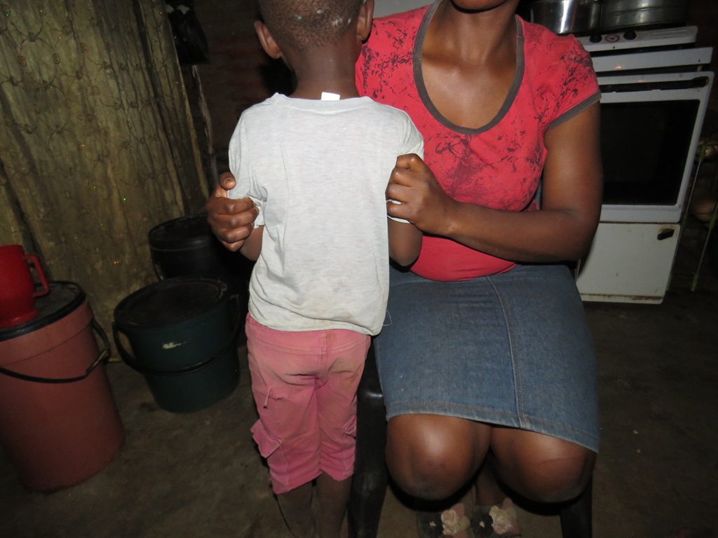 A mother and her son who saved himself from drowning after slipping into a manhole in Etwatwa.                      Photo by Phineas Khoza