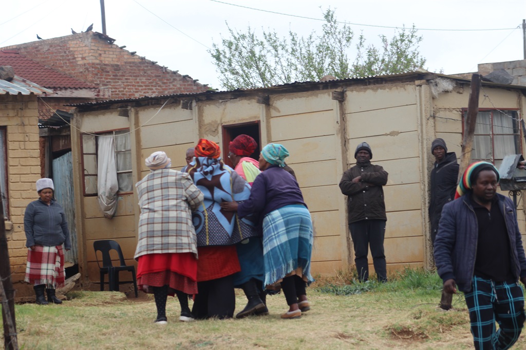 Family members and neighbours near the scene where a 27-year-old man killed himself in QwaQwa. 