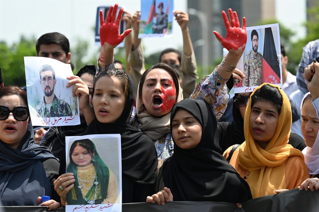 Afghan nationals carry placards as shout slogans during a demonstration against the Taliban government in Islamabad on 15 August 2023, on the occasion of the second anniversary of the Taliban takeover of Afghanistan.