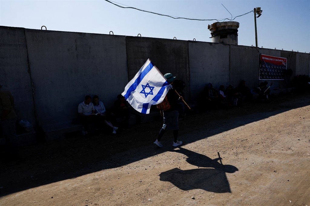 A demonstrator carries an Israeli flag during a pr