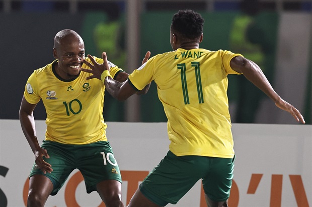 <p><strong>HALF-TIME: Bafana Bafana 3-0 Namibia</strong></p><p>What a remarkable half! Exactly what Bafana needed, especially given their historical challenges in the attacking department.&nbsp;</p><p>Percy Tau's successful penalty and a brace from Themba Zwane have propelled Hugo Broos's charges to a robust and commanding lead.</p><p>There were chances for Namibia in the early stages of the match, in which SA looked rattled but kept their composure.&nbsp;</p><p>When the second half begins, Namibia will need to capitalize on their opportunities and be more clinical. </p><p>Meanwhile, Bafana must remain vigilant from the outset, protecting their lead and, if possible, extending it with additional goals.</p><p><em>AFP IMAGE:&nbsp;South Africa's forward #11 Themba Zwane celebrates with teammates after scoring his team's third goal during the Africa Cup of Nations (CAN) 2024 group E football match between South Africa and Namibia at Amadou Gon Coulibaly Stadium in Korhogo on January 21, 2024. (Photo by Fadel Senna / AFP)</em></p>