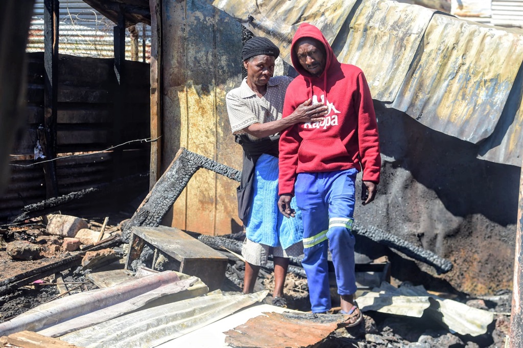 The gogo of the three dead children, Johanna Maswanganye and their father Johannes Maswanganye, at the scene of the deadly incident. Photo by Raymond Morare