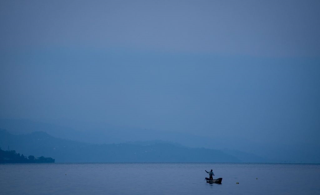 A fisherman is catching his nets early in the morning on Lake Kivu. (Photo by Kay Nietfeld/picture alliance via Getty Images)