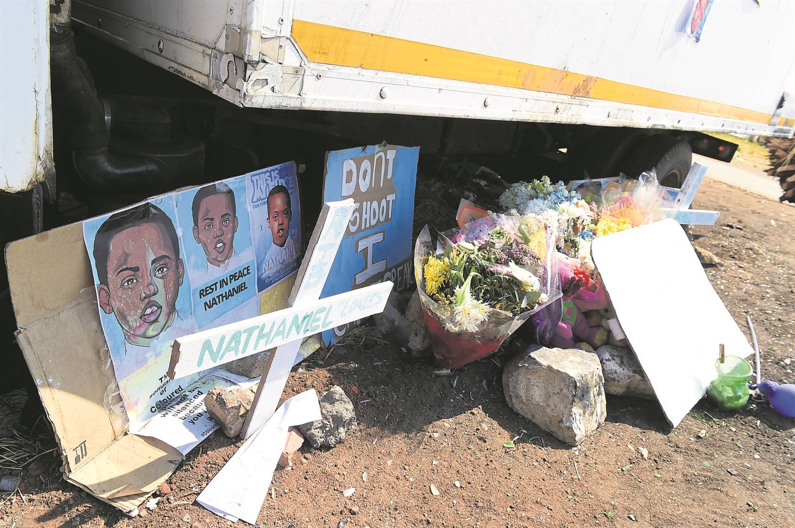 Crosses, flowers and banners printed with messages of support at the scene where Nathaniel Julies was killed allegedly by SAPS Officers. Photo by Morapedi MashashePhoto by 